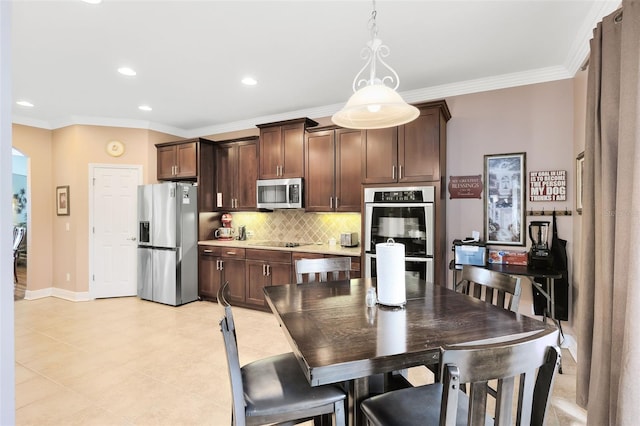 dining area with crown molding, recessed lighting, baseboards, and light tile patterned flooring