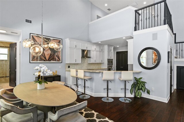 1840 Bryan Ave, Winter Park, FL 32789 - kitchen featuring a notable chandelier, extractor fan, visible vents, and a towering ceiling