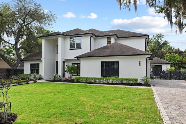 1840 Bryan Ave, Winter Park, FL 32789 - view of front of house with decorative driveway, a front lawn, roof with shingles, and stucco siding
