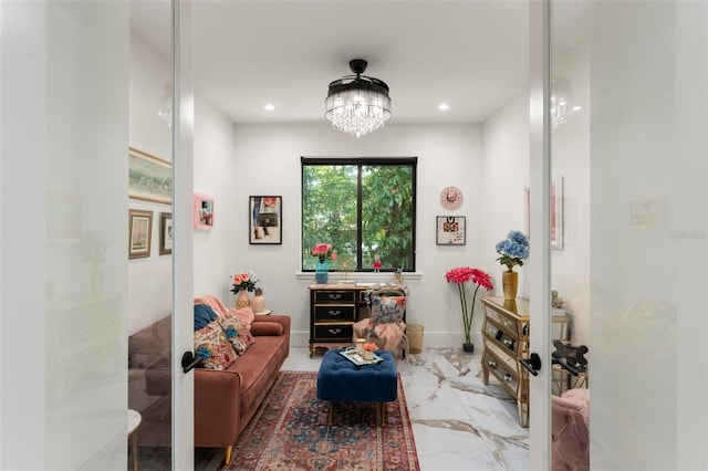 living area featuring an inviting chandelier, recessed lighting, and marble finish floor