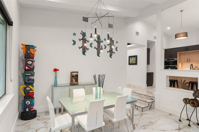 dining space with an inviting chandelier, beam ceiling, high vaulted ceiling, marble finish floor, and visible vents
