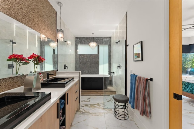 bathroom with a tile shower, a sink, double vanity, marble finish floor, and a freestanding tub