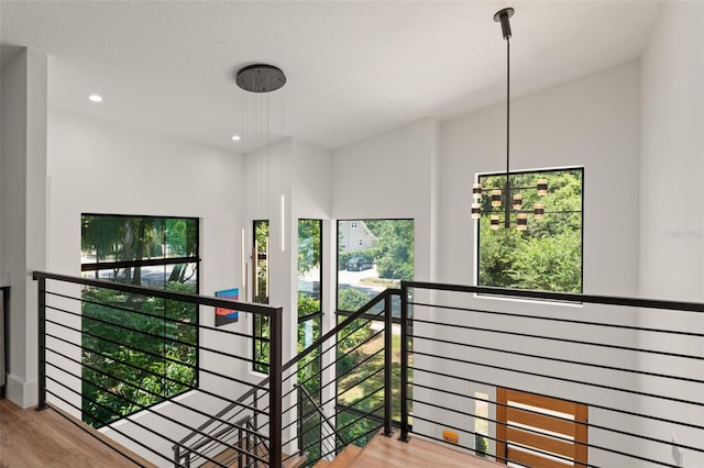 stairs featuring recessed lighting and wood finished floors