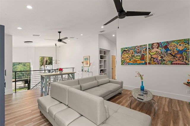 living area featuring a ceiling fan, baseboards, recessed lighting, and visible vents