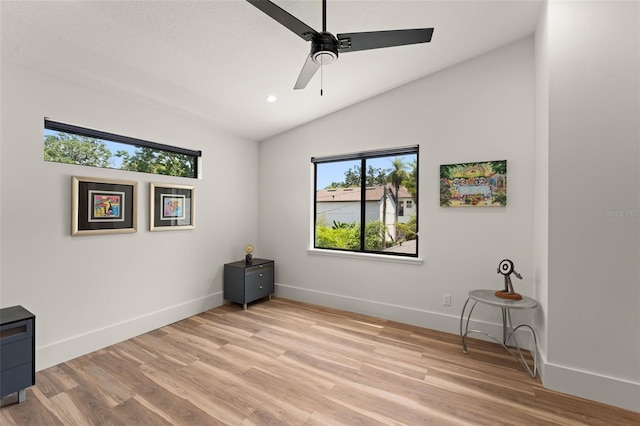 interior space with ceiling fan, light wood-style floors, recessed lighting, baseboards, and lofted ceiling
