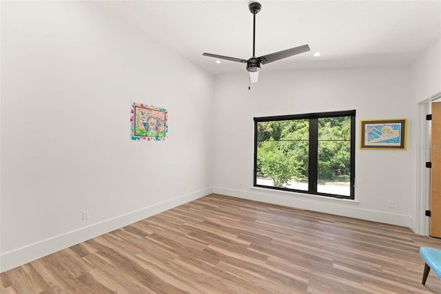 spare room with baseboards, recessed lighting, light wood finished floors, and ceiling fan