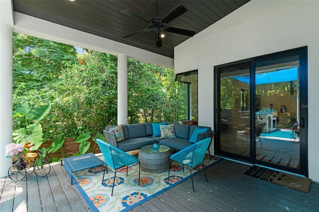 wooden deck featuring ceiling fan and an outdoor living space