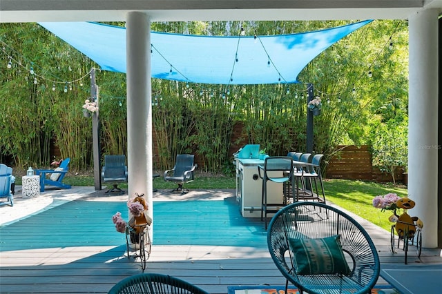 wooden terrace with outdoor dining area and fence