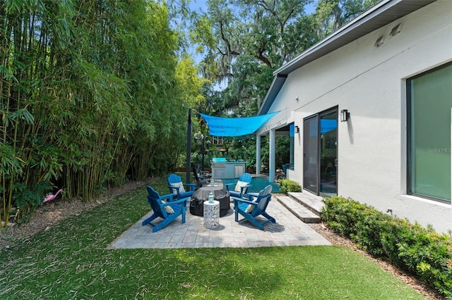 view of yard featuring a patio and a fire pit