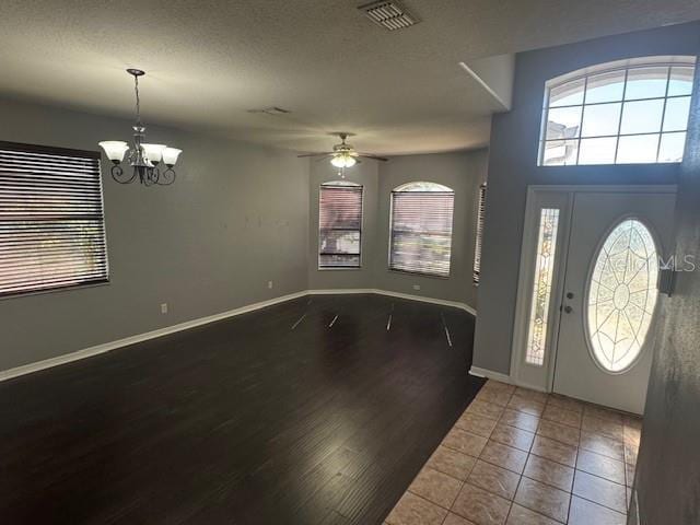 10414 Andover Point Cir, Orlando, FL 32825 - entrance foyer with a wealth of natural light, ceiling fan with notable chandelier, and visible vents