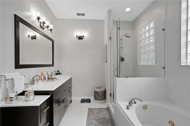 10414 Andover Point Cir, Orlando, FL 32825 - bathroom featuring visible vents, vanity, a jetted tub, baseboards, and a shower stall