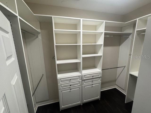 10414 Andover Point Cir, Orlando, FL 32825 - walk in closet featuring dark wood finished floors