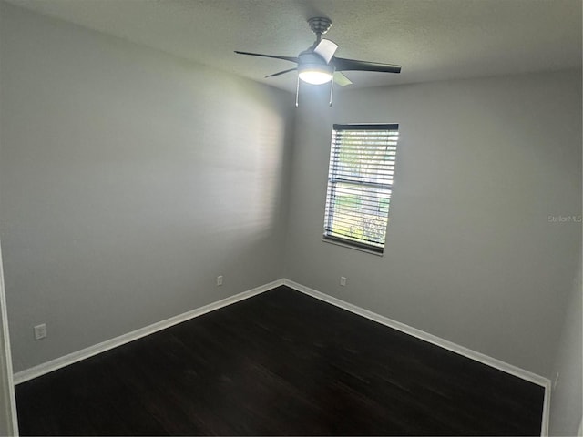 10414 Andover Point Cir, Orlando, FL 32825 - unfurnished room with a textured ceiling, ceiling fan, dark wood finished floors, and baseboards