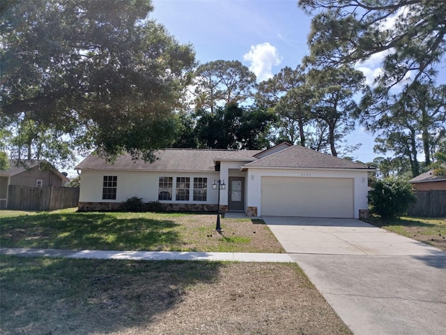 single story home with driveway, a front yard, fence, an attached garage, and stucco siding