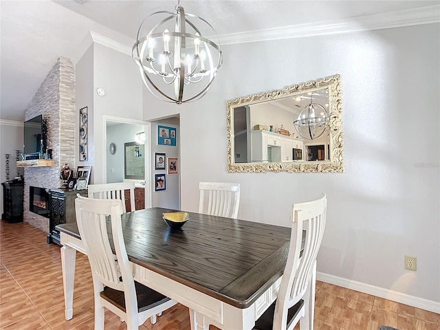 1072 SE 155th St, Summerfield, FL 34491 - dining area featuring an inviting chandelier, a stone fireplace, baseboards, light wood-type flooring, and ornamental molding