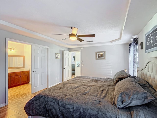 1072 SE 155th St, Summerfield, FL 34491 - bedroom featuring connected bathroom, ceiling fan, visible vents, and a raised ceiling