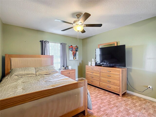 1072 SE 155th St, Summerfield, FL 34491 - bedroom with baseboards, a ceiling fan, and a textured ceiling