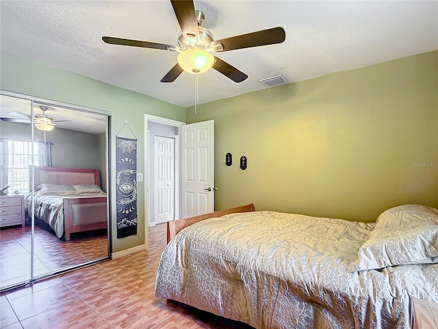 1072 SE 155th St, Summerfield, FL 34491 - tiled bedroom with baseboards, a ceiling fan, a closet, and visible vents