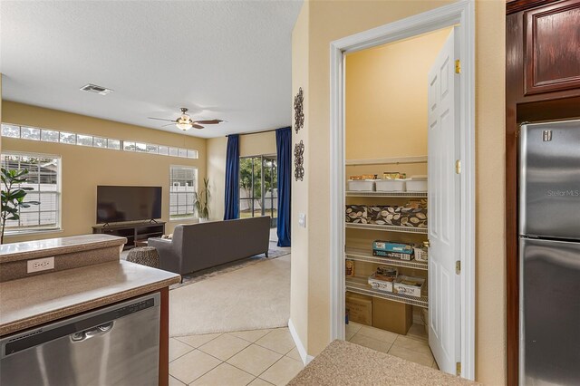 interior space featuring visible vents, light carpet, and light tile patterned floors