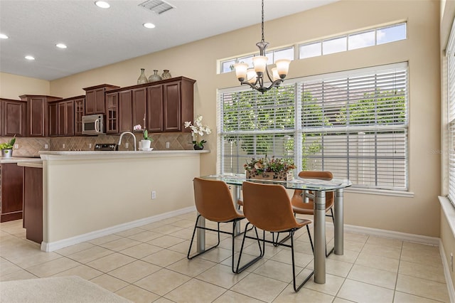 dining area featuring recessed lighting, a notable chandelier, visible vents, and light tile patterned flooring