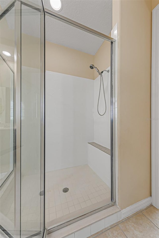 bathroom featuring tile patterned floors and a stall shower