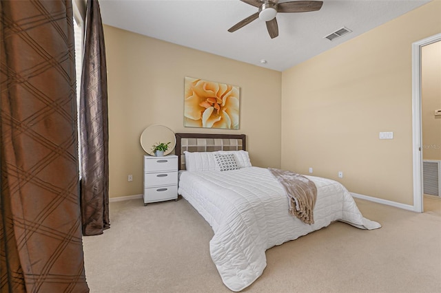 bedroom with baseboards, light colored carpet, ceiling fan, and visible vents