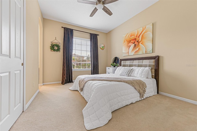 carpeted bedroom featuring baseboards and ceiling fan