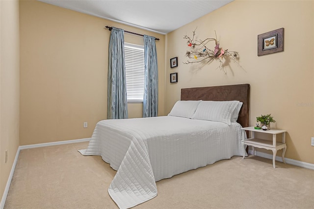 carpeted bedroom with baseboards