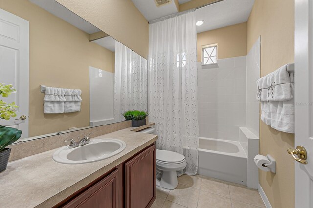 bathroom featuring visible vents, tile patterned floors, vanity, toilet, and shower / bath combo with shower curtain