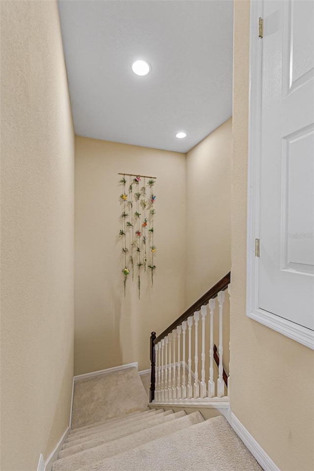 staircase with baseboards, carpet flooring, and recessed lighting