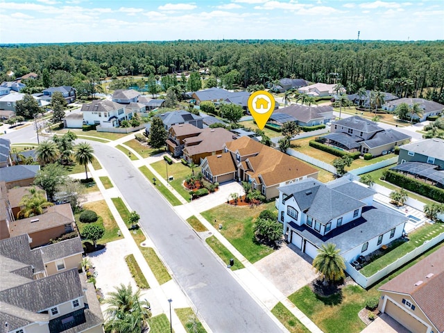 birds eye view of property featuring a residential view and a forest view