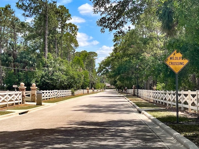 view of community with fence