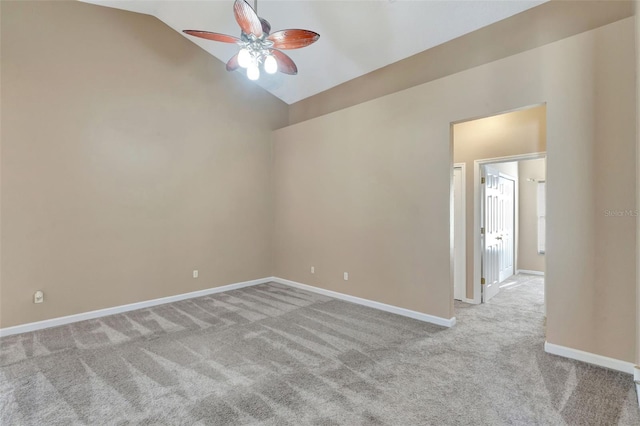 empty room with a ceiling fan, carpet, lofted ceiling, and baseboards