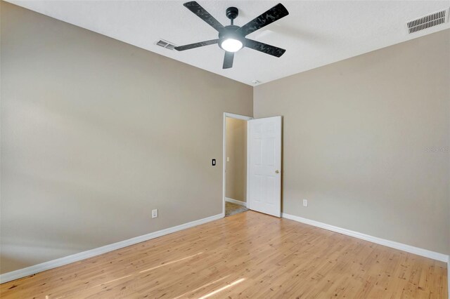 unfurnished room featuring baseboards, light wood-style floors, and a ceiling fan