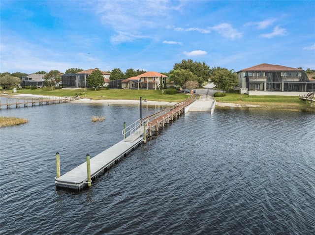 dock featuring a water view and a yard