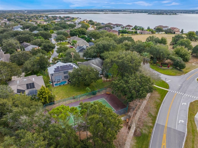 aerial view of property and surrounding area with a large body of water and nearby suburban area