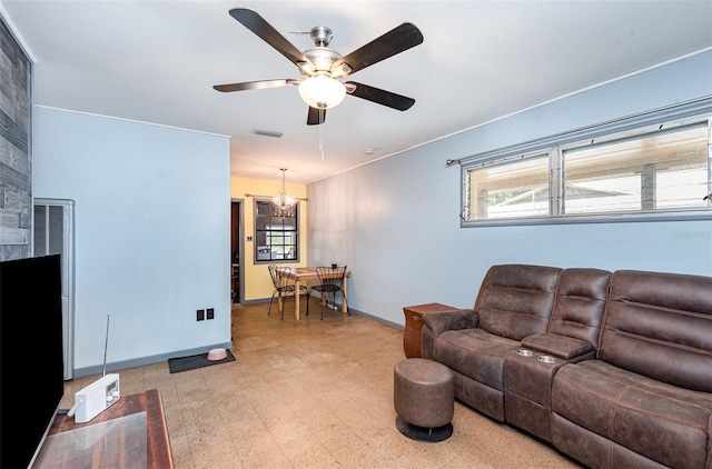 living room with visible vents, plenty of natural light, ceiling fan with notable chandelier, and light floors