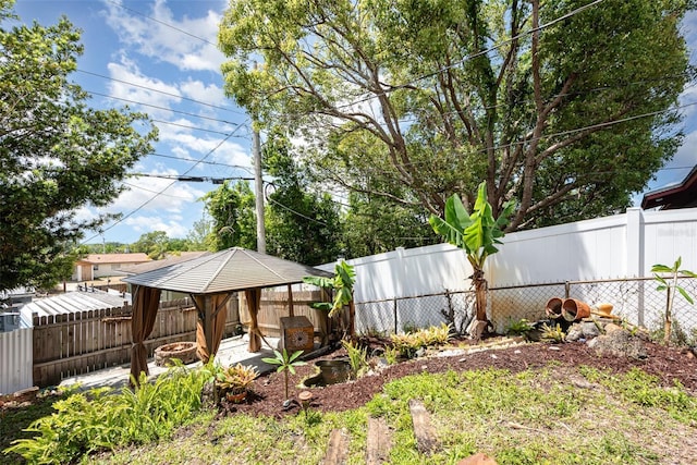 view of yard featuring a gazebo and a fenced backyard