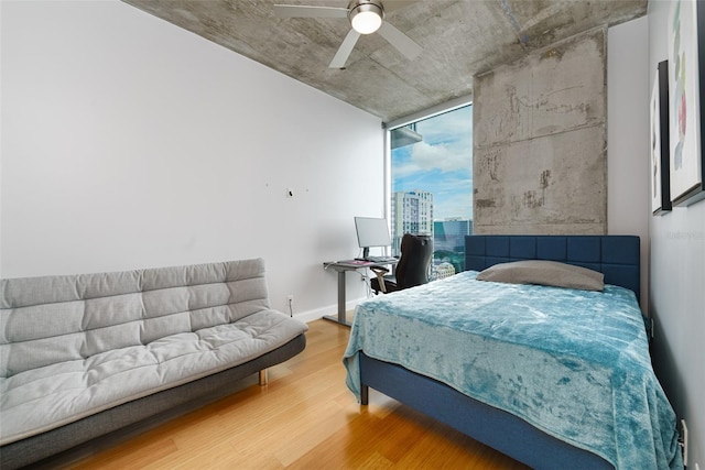155 S Court Ave Unit 1305, Orlando, FL 32801 - bedroom featuring a ceiling fan, baseboards, and wood finished floors