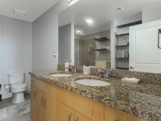 155 S Court Ave Unit 1305, Orlando, FL 32801 - full bathroom with double vanity, visible vents, a shower stall, and a sink
