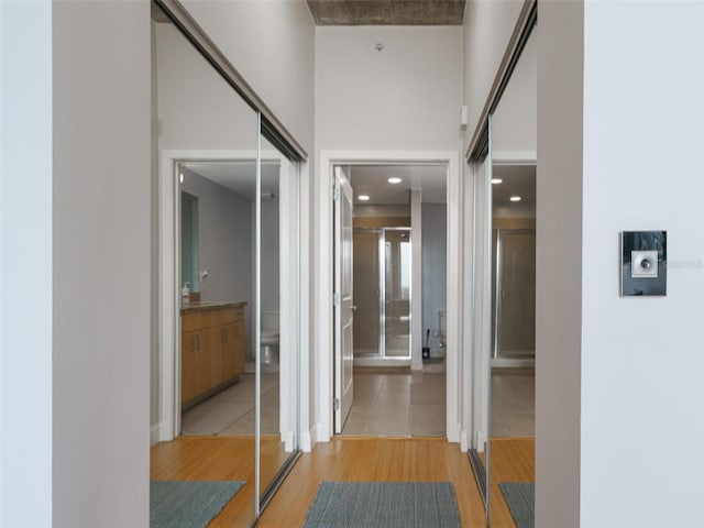 155 S Court Ave Unit 1305, Orlando, FL 32801 - hallway with a high ceiling and light wood-style flooring