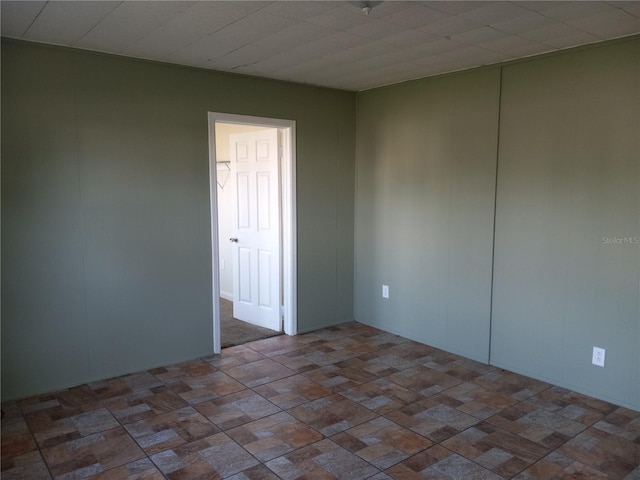 empty room with brick patterned floor