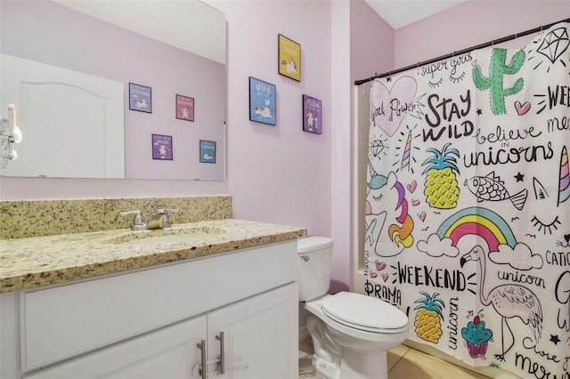 full bathroom with toilet, vanity, and tile patterned flooring