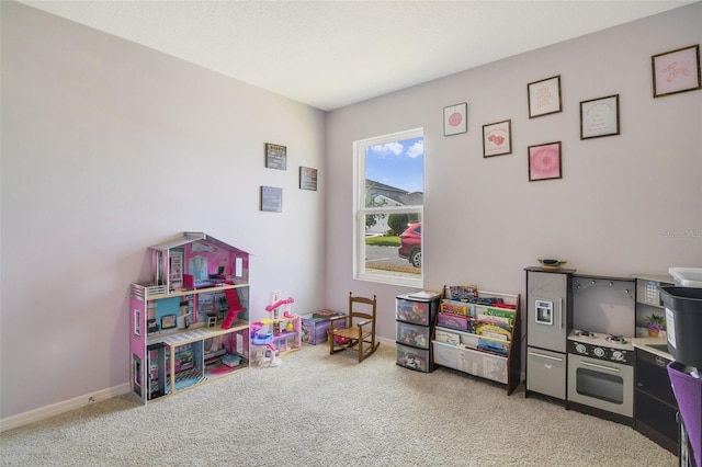 playroom featuring carpet flooring and baseboards