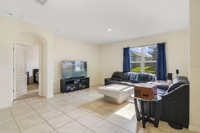 living area featuring light tile patterned floors and baseboards