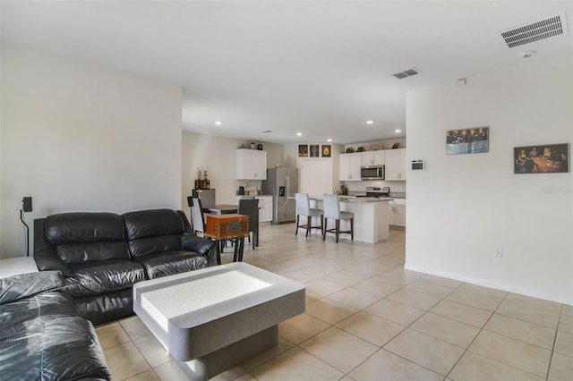 living area with light tile patterned floors and recessed lighting