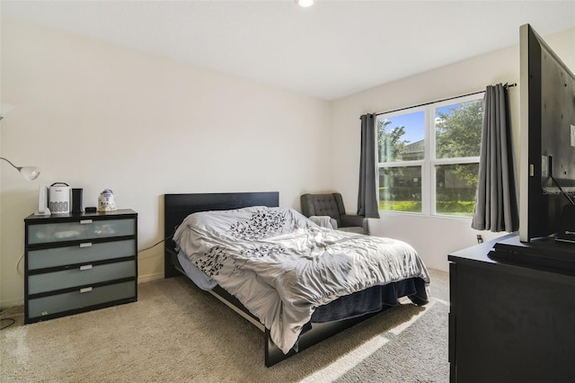 bedroom featuring light colored carpet