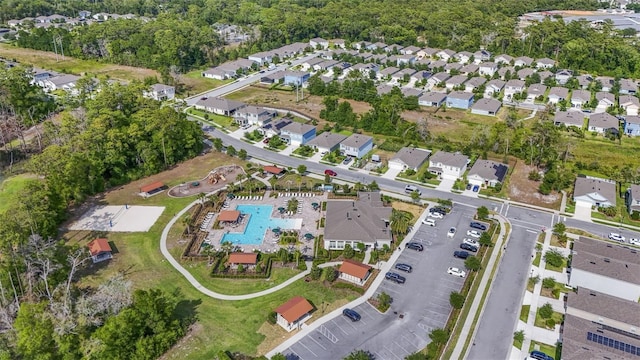 view of property location with a pool area and nearby suburban area
