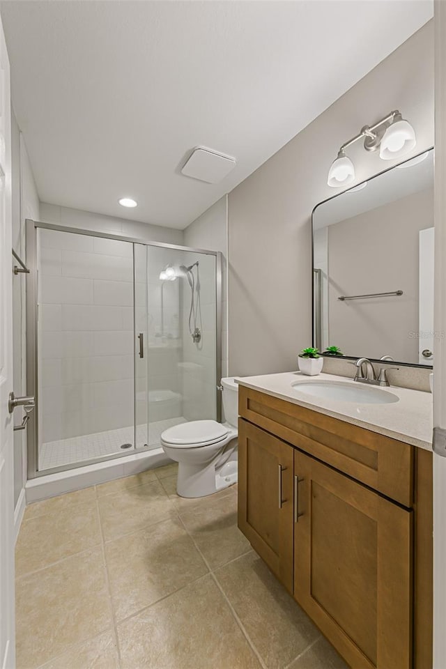 bathroom with toilet, a stall shower, vanity, and tile patterned floors