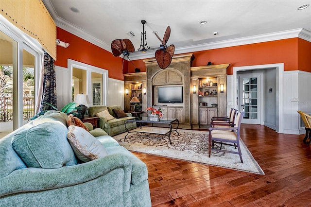 living room featuring crown molding and wood finished floors